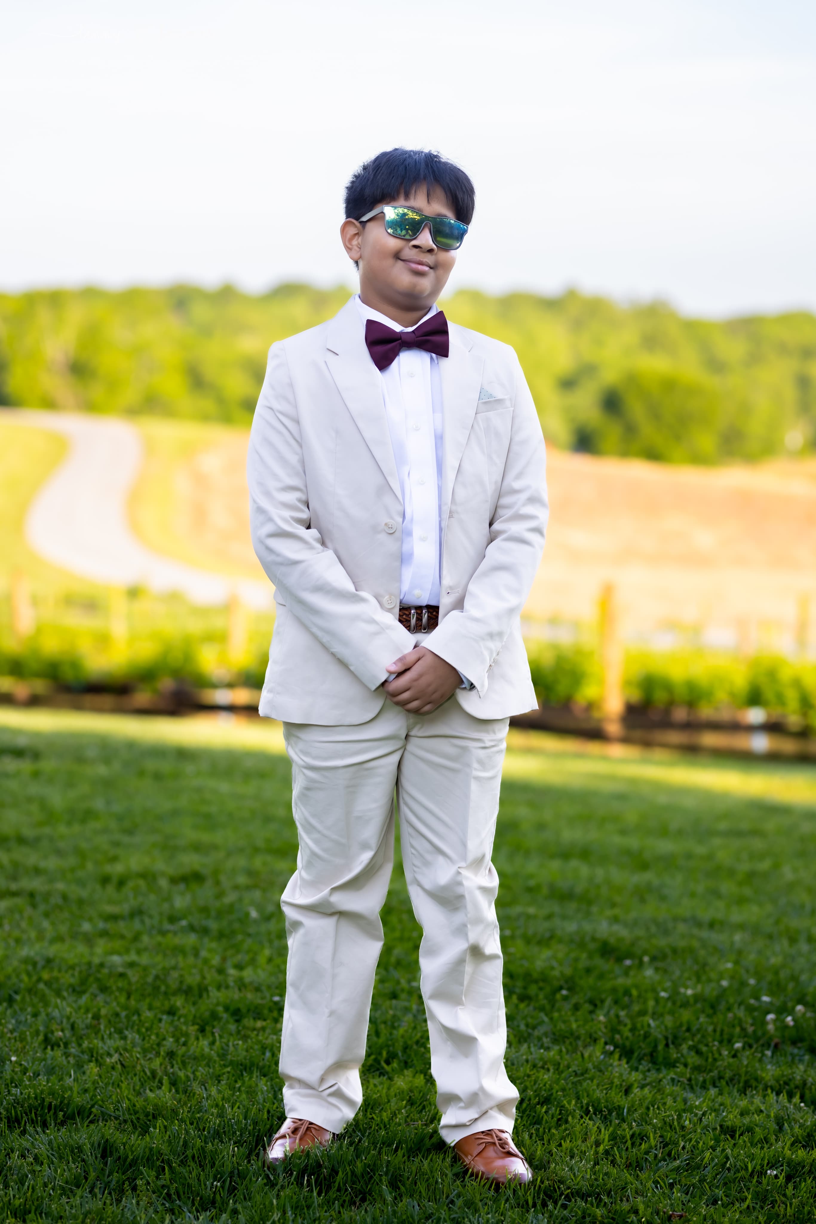 Formal portrait in a white suit outdoors